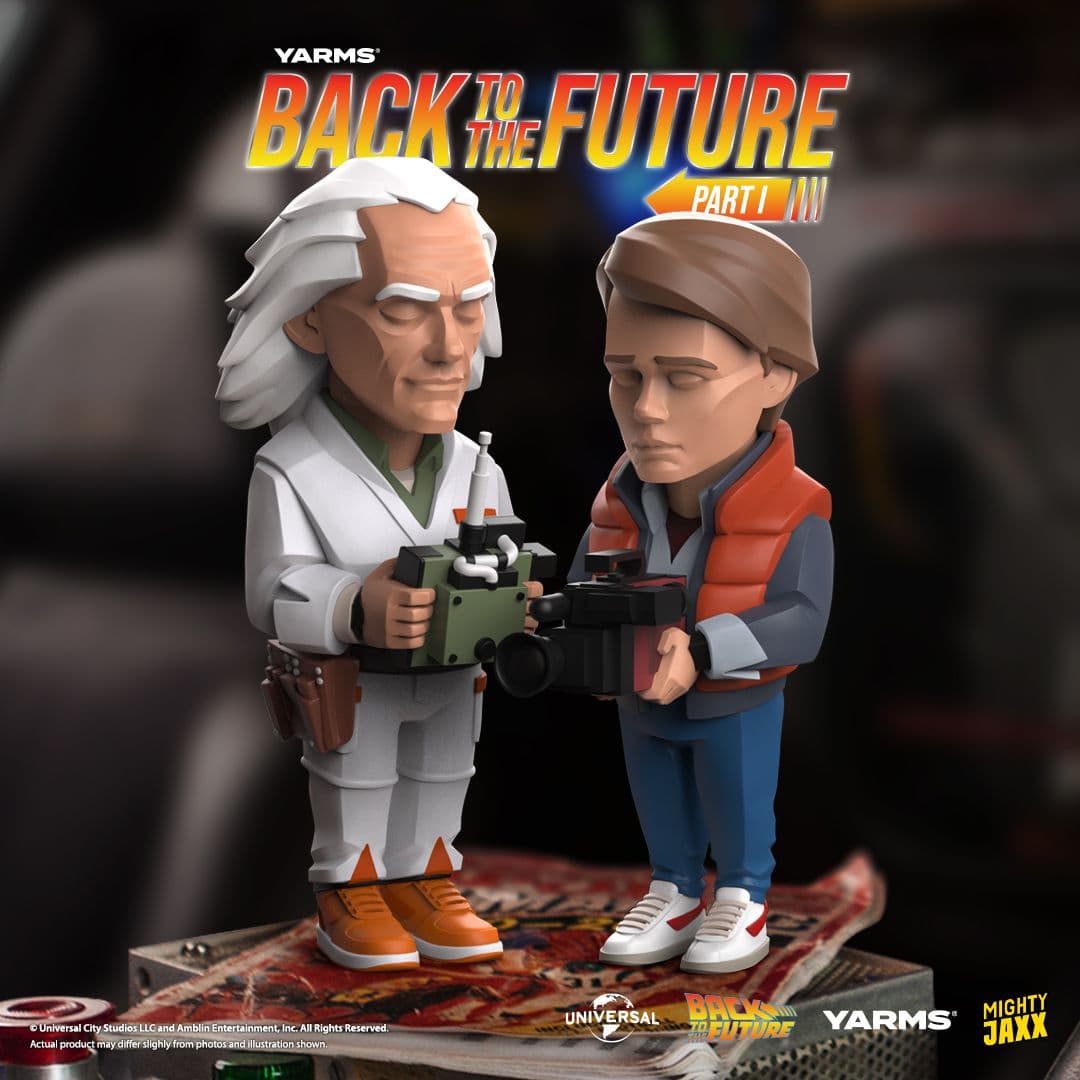 Back to the Future figures of Doc Brown and Marty McFly standing together, holding remote control and camera respectively