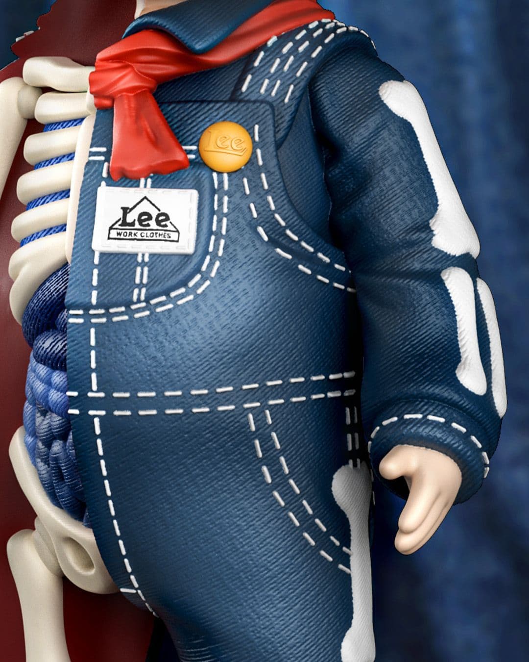 Mid-body view of figure highlighting Lee denim overall textures, stitching, red scarf and visible skeletal structure.