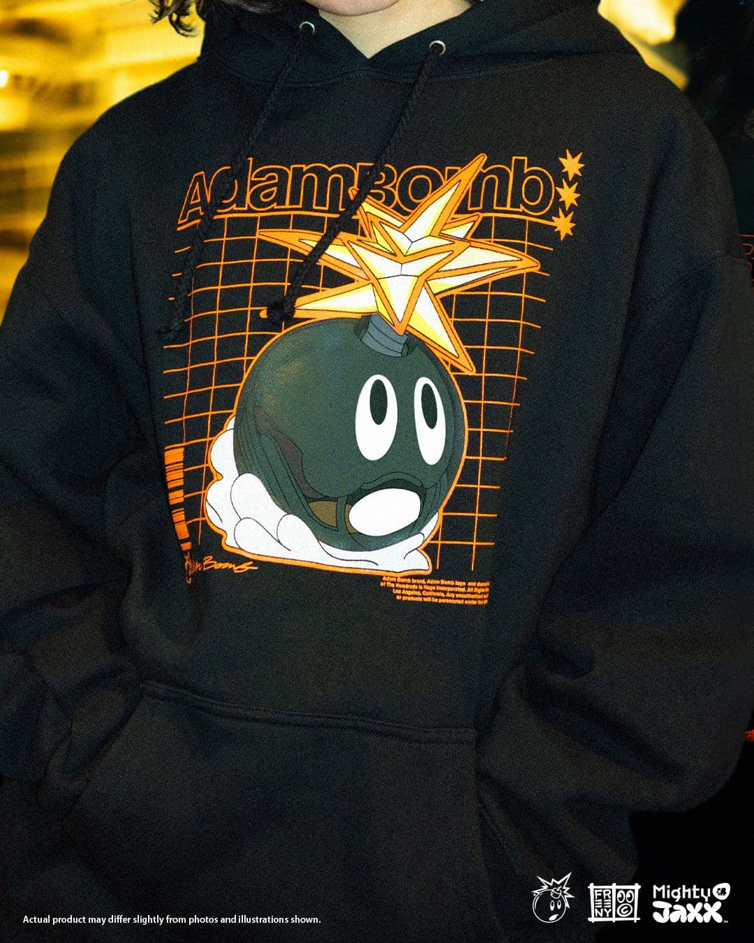 Front view of black Adam Bomb hoodie featuring large Adam Bomb graphic with starburst explosion and orange grid design.